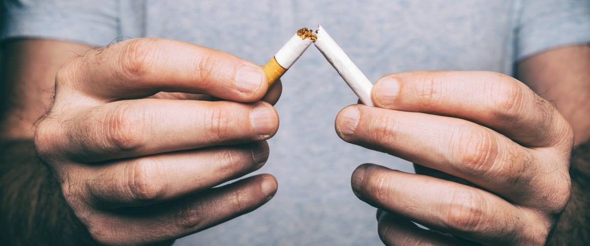Quit smoking - male hand crushing cigarette