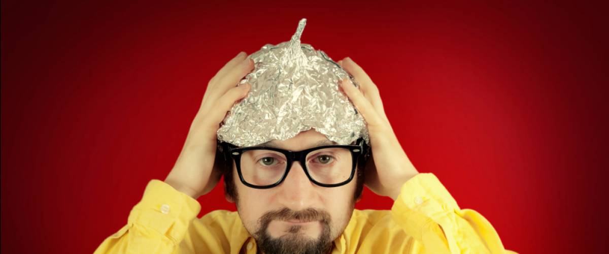 man wearing a tinfoil hat, conspiracy theory concept