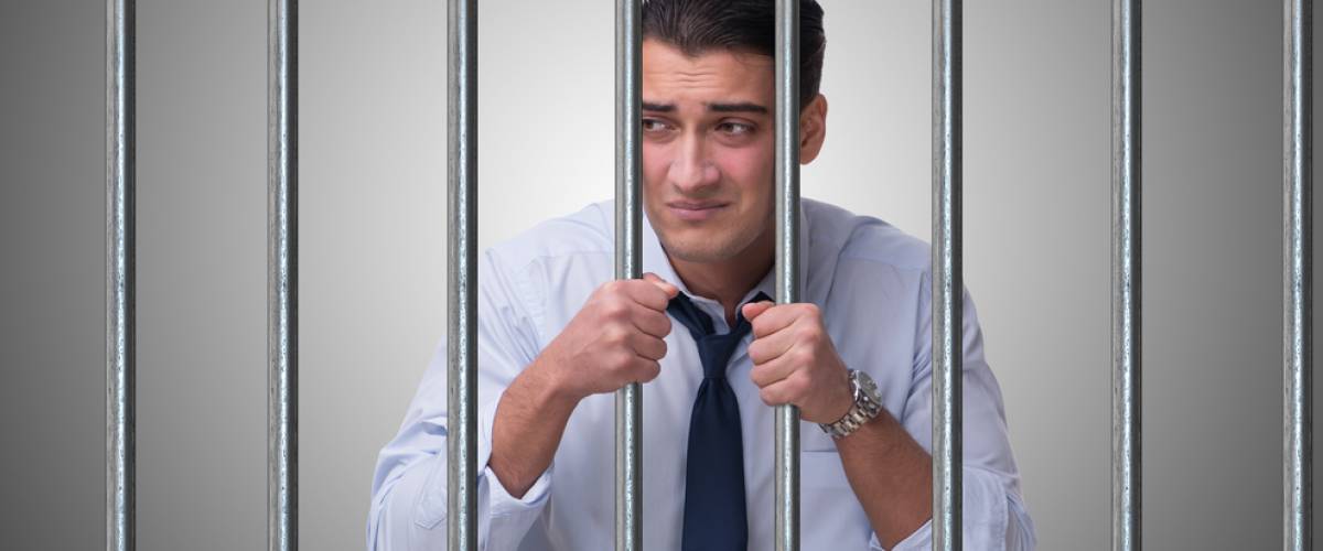 businessman behind bars