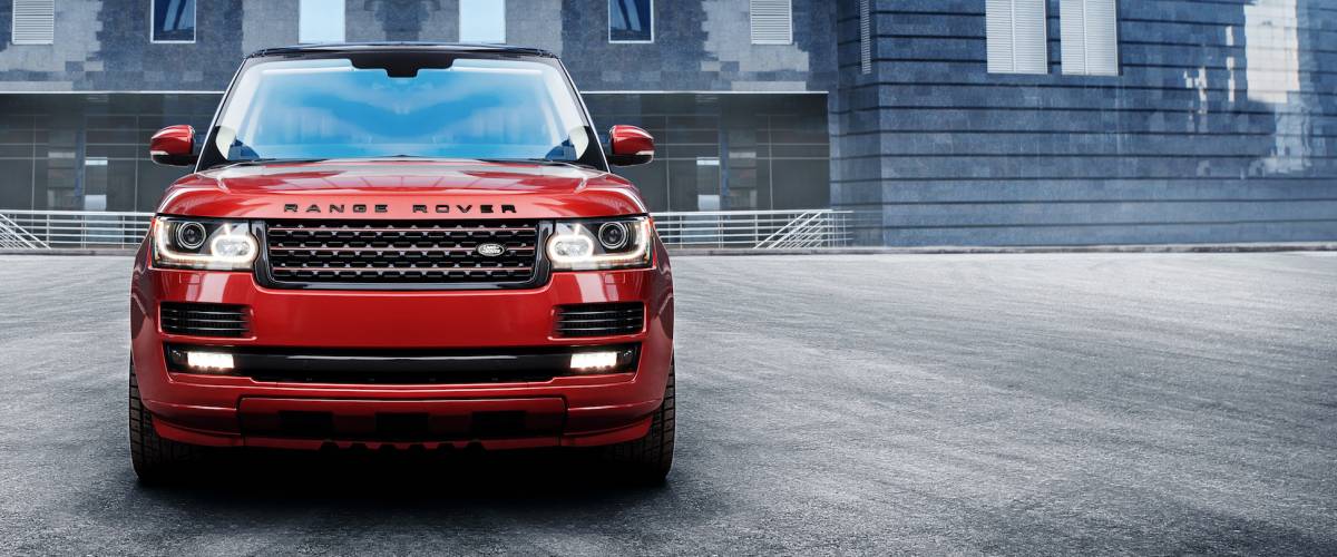 Land Rover Range Rover standing near modern building in the city at daytime