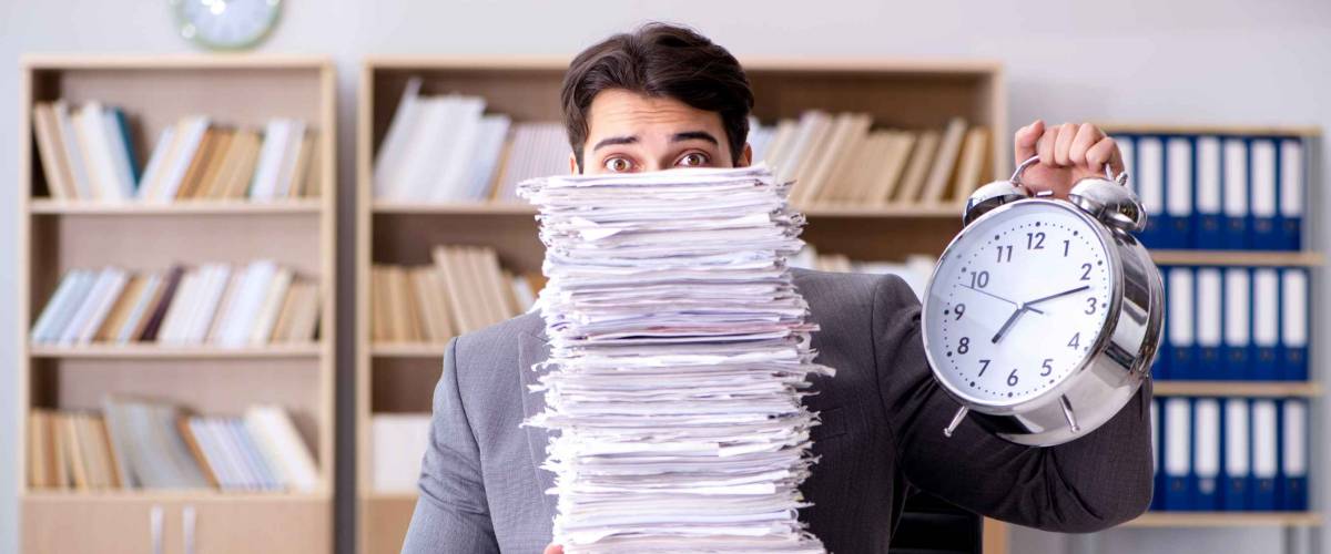 Businessman struggling to meet challenging deadlines