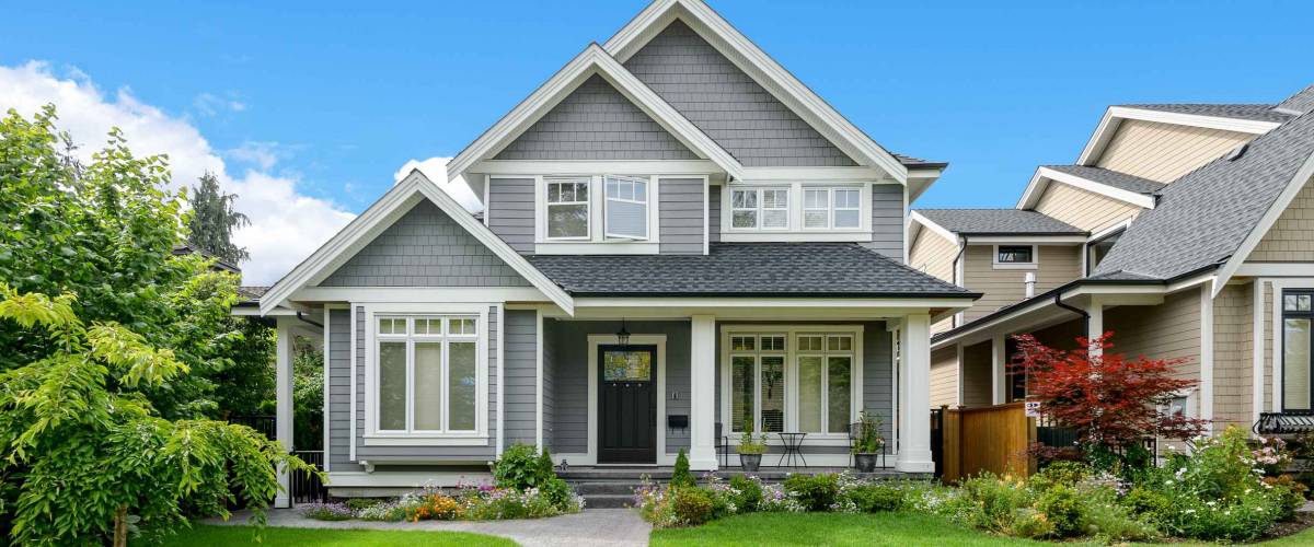Luxury house with beautiful landscaping on a sunny day. Home exterior.