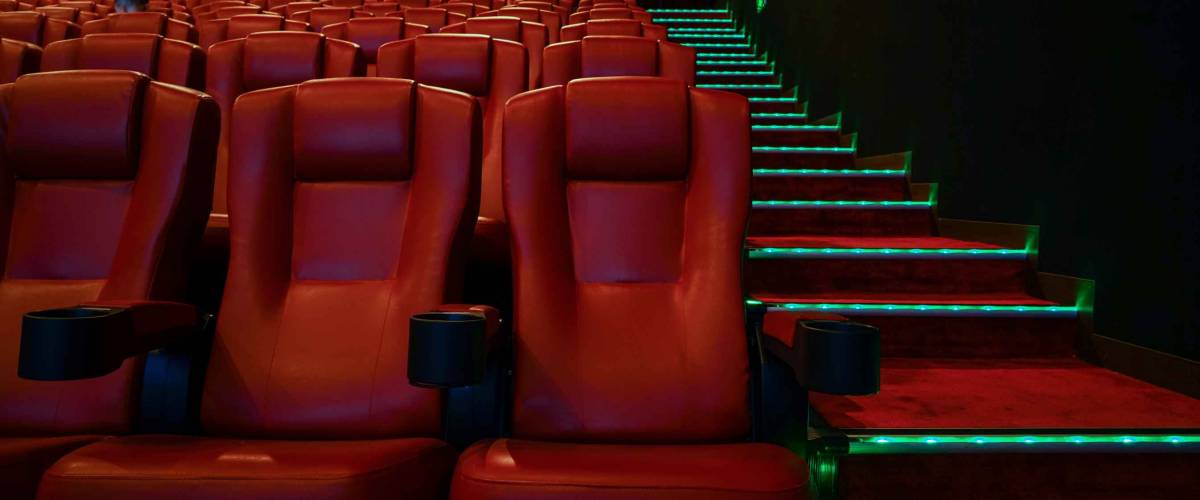 Movie theater with red seats in luxury hotel.
