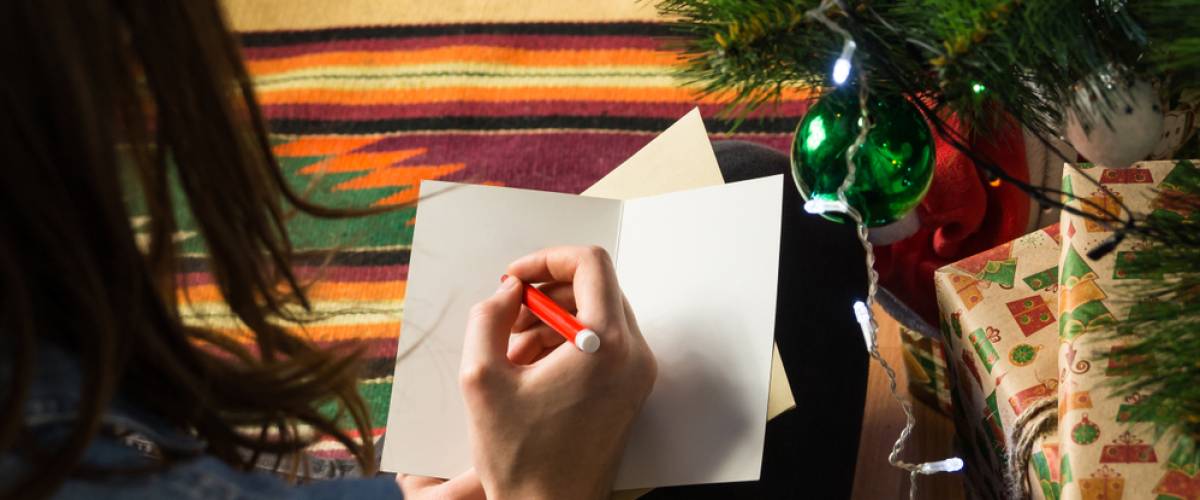 Woman writing in a blank card