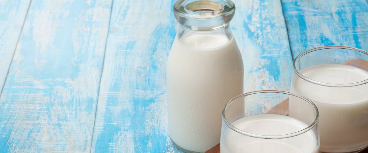 Container and glasses of milk