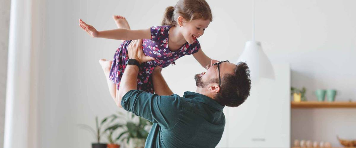 Father's day. Happy family daughter hugs his dad on holiday