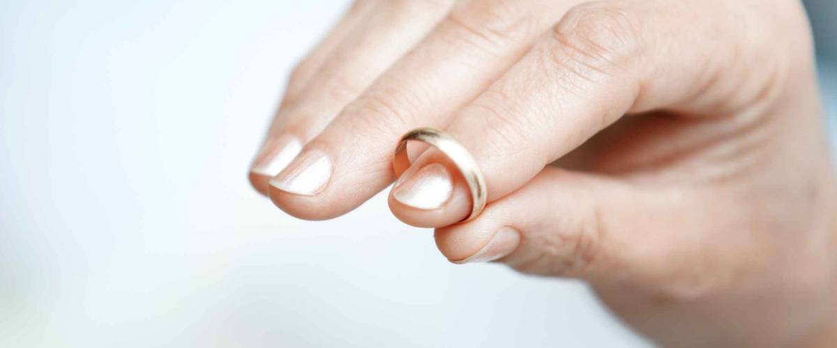 Hand of senior woman holding engagement ring