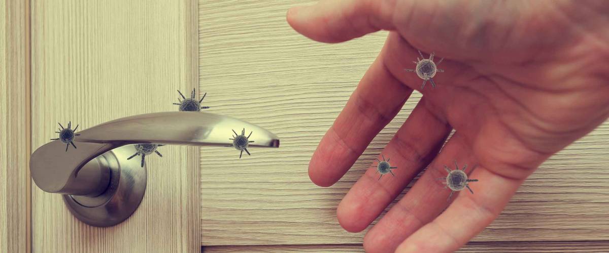 human hand reaching out to open a door handle,  the concept of germs sitting on the door handle