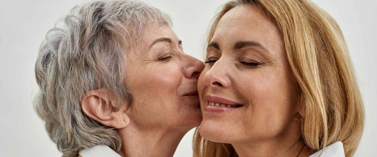 Close up of older Caucasian woman kissing the cheek of another woman