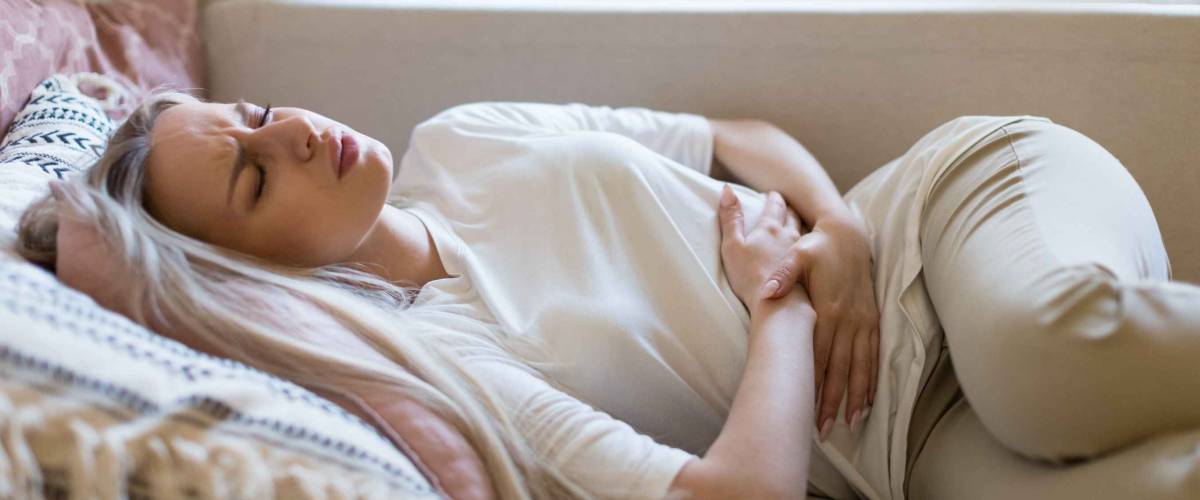 Health issues problems.Young Caucasian woman suffering from stomach pain