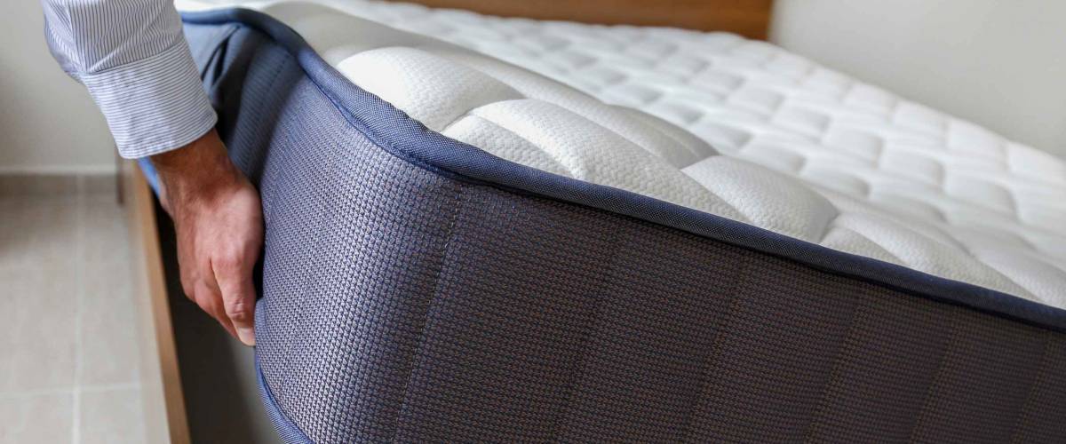 New bed delivery, close up of large mattress being placed down