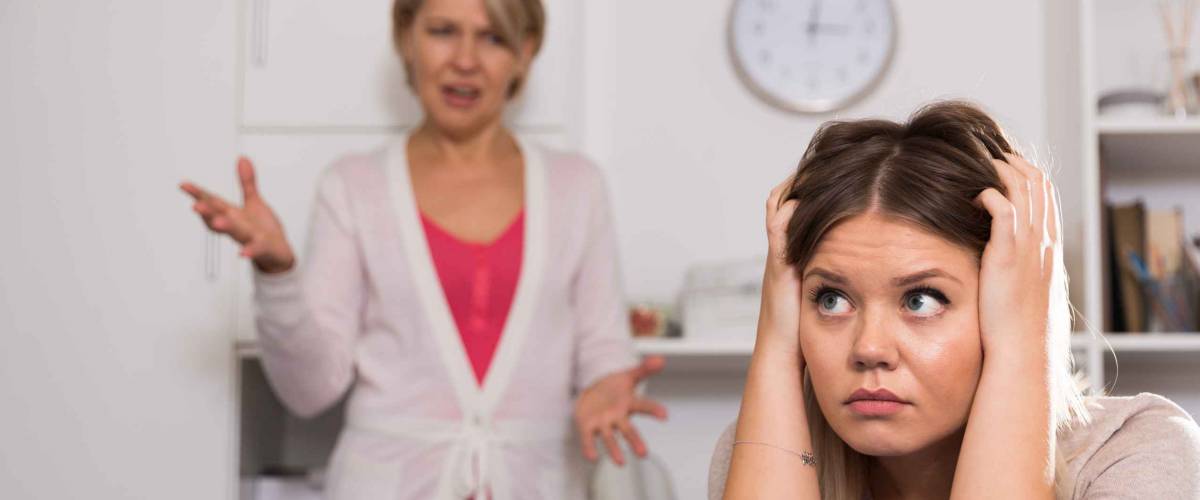 Angry mother scolds her adult sad daughter