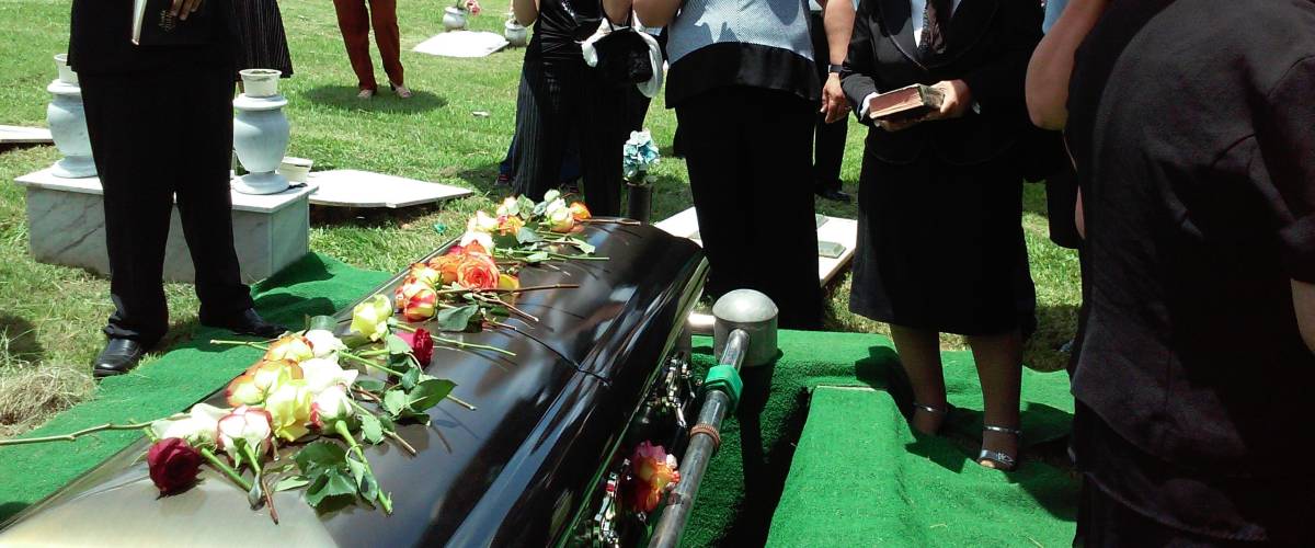 Group of people gathered around for funeral