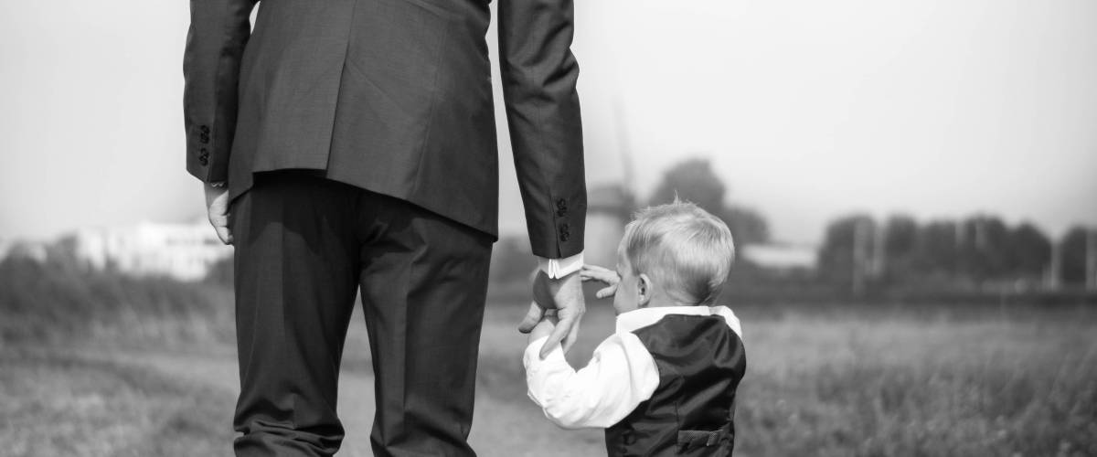 Man walking holding hand on ring boy
