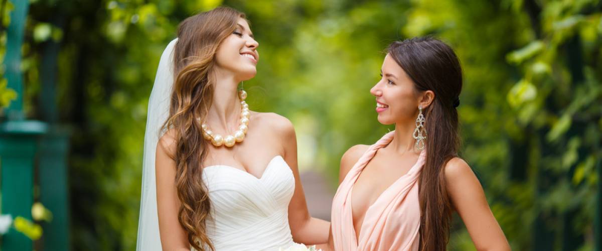 Bride and sister posing together