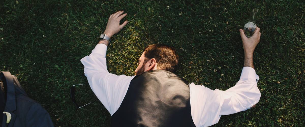 Man drunk lying in grass