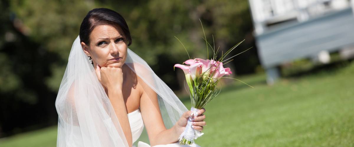 Bride sitting alone with bouquet