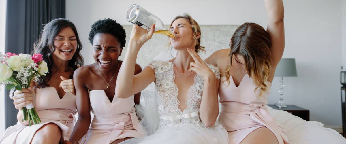 Bride and bridesmaids drinking