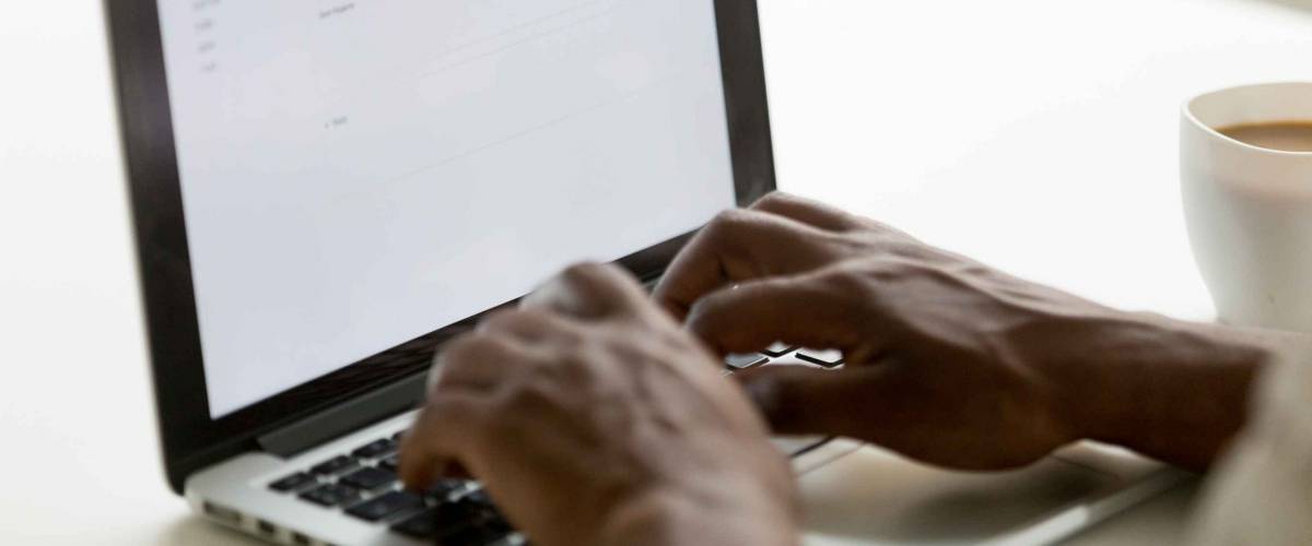 Businessman typing a letter on a laptop computer