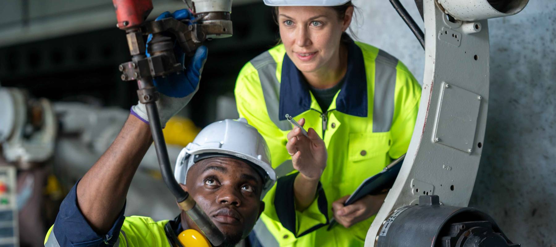 engineer inspect robotic arm in workshop