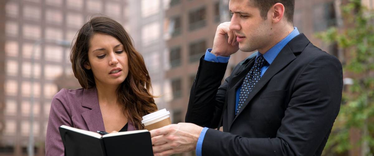 Personal assistant with boss on the move fast pace high stress occupation downtown urban buildings
