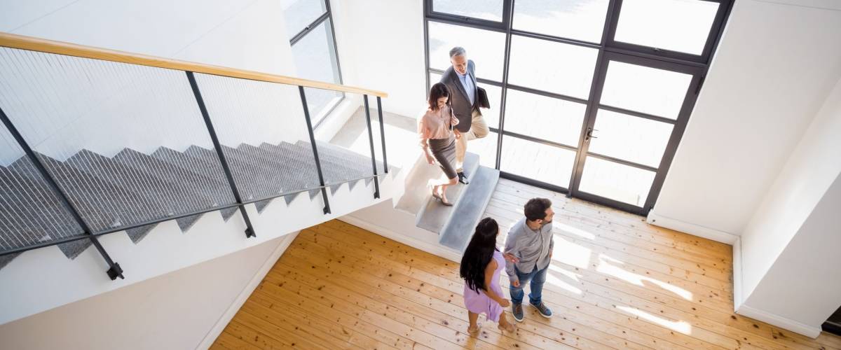 Real estate agent showing new house to couple