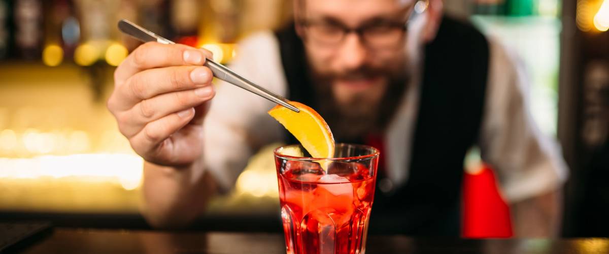 Bartender making alcohol coctail in restaurant