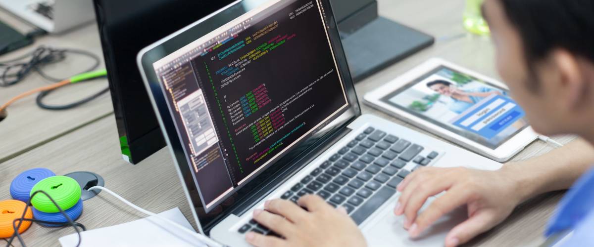 Asian Developer Using Laptop Computer Sitting Working Real Office