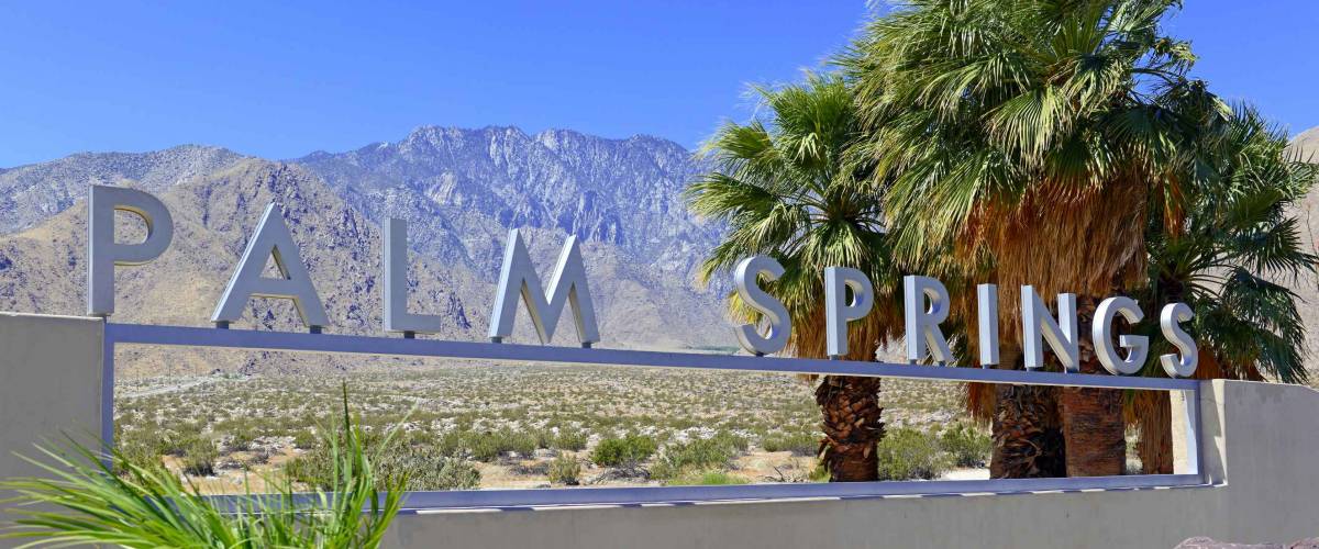 Palm Springs sign with desert background and backdrop of San Jacinto Mountain, California