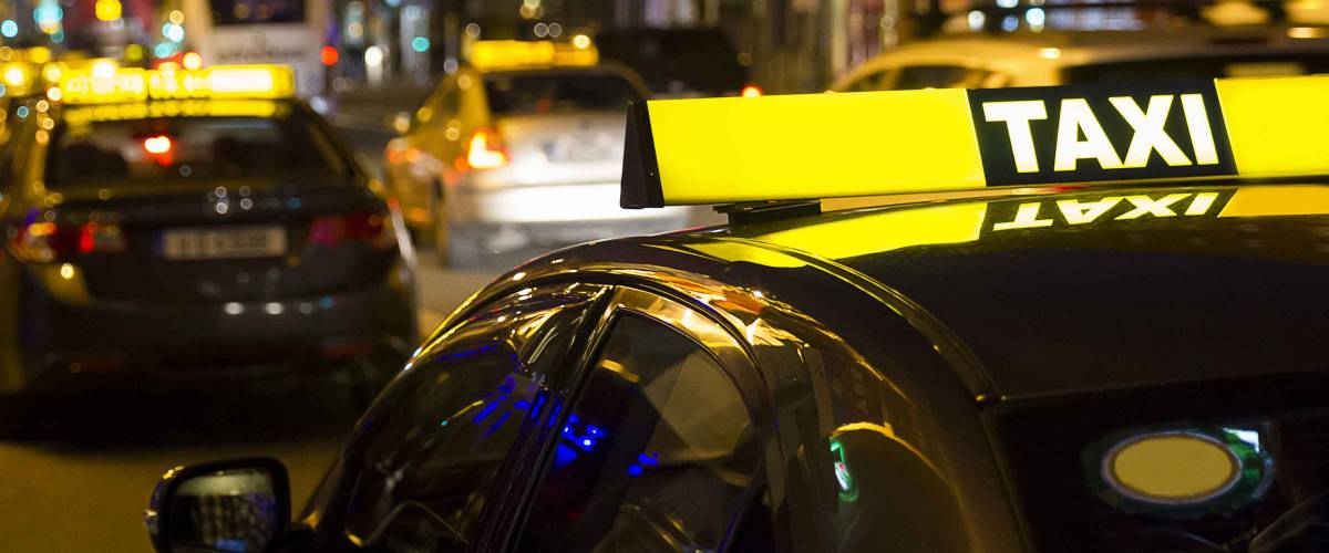 Taxi service in the city in the night.