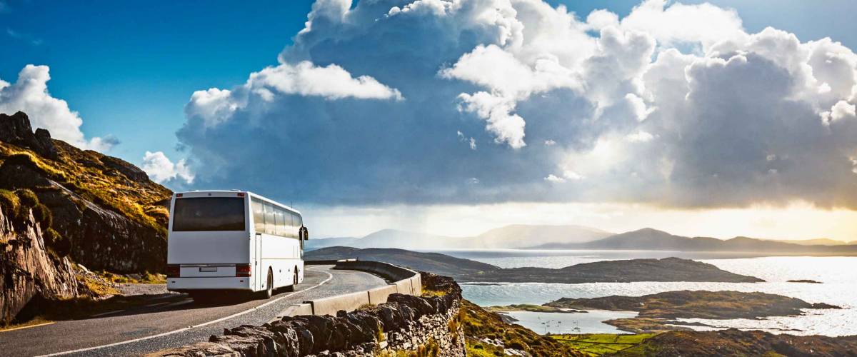 Tourist bus traveling on mountain road. Ring of Kerry, Ireland. Travel destination