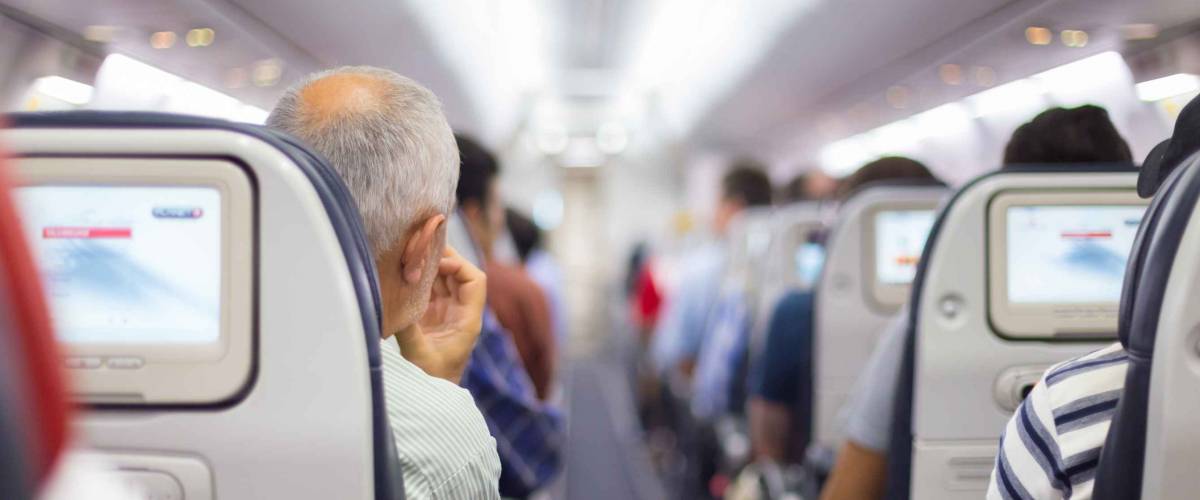 Interior of airplane with passengers on seats waiting to taik off.