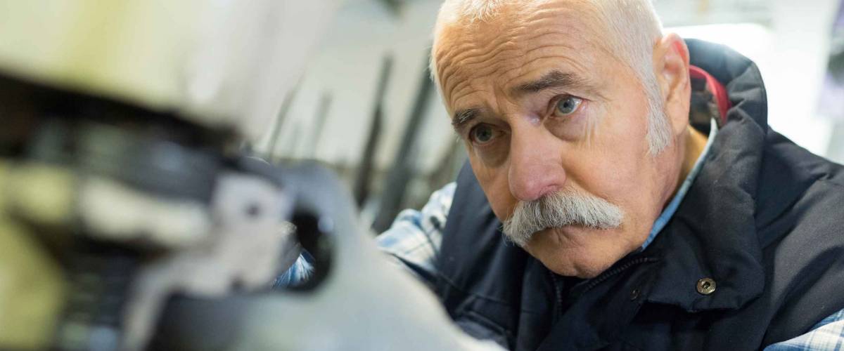 aged man working in an industrial factory