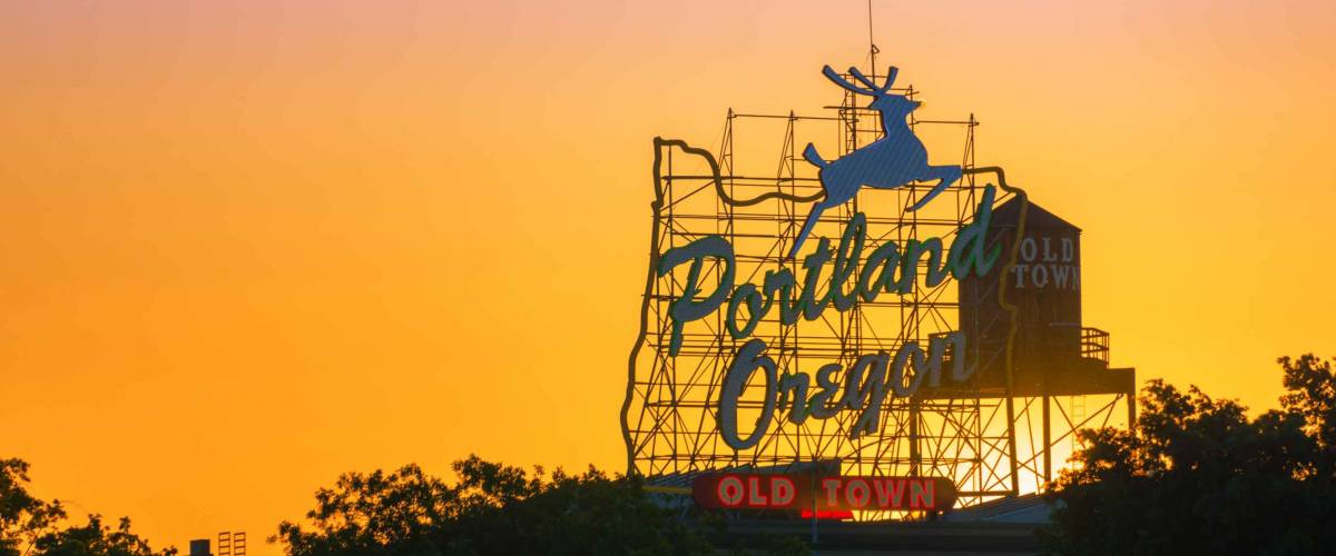 Sunset over the iconic Portland, Oregon Old Town sign in downtown Portland, Oregon