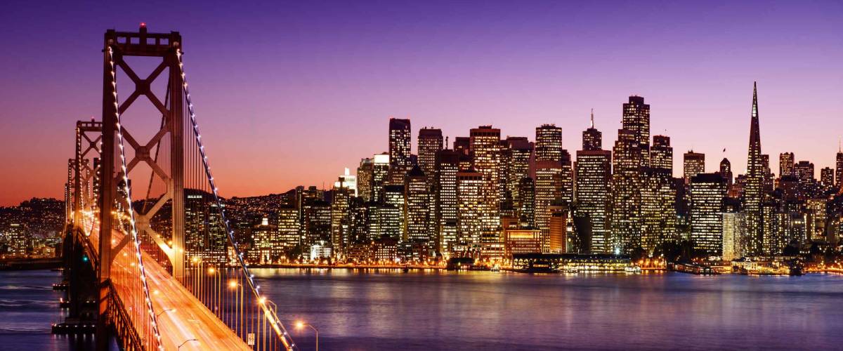 San Francisco skyline and Bay Bridge at sunset, California