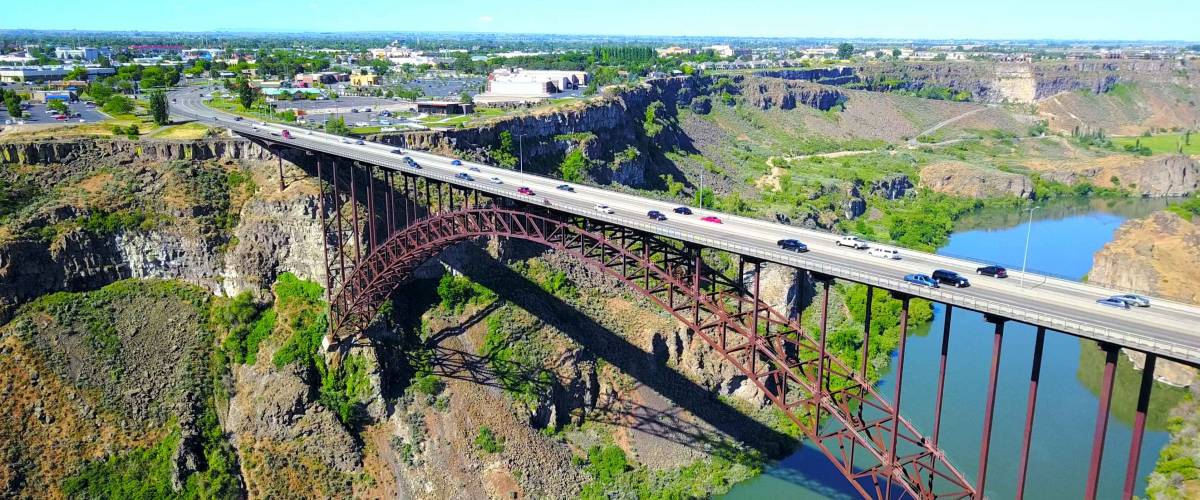 Perrine Bridge, Twin Falls, Idaho, USA - Distant Aerial View Over River Canyon With Cars Driving On Road