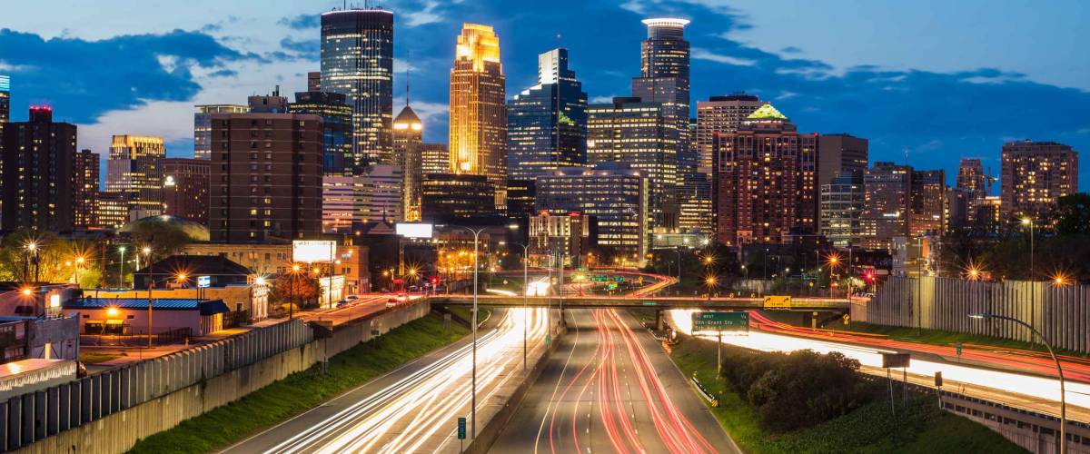 Heavy traffic flowing in and out of Minneapolis during a beautiful sunset Shot with a long exposure creating light trails from the moving traffic.
