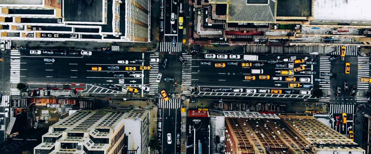 Aerial view of New York downtown building roofs and traffic.