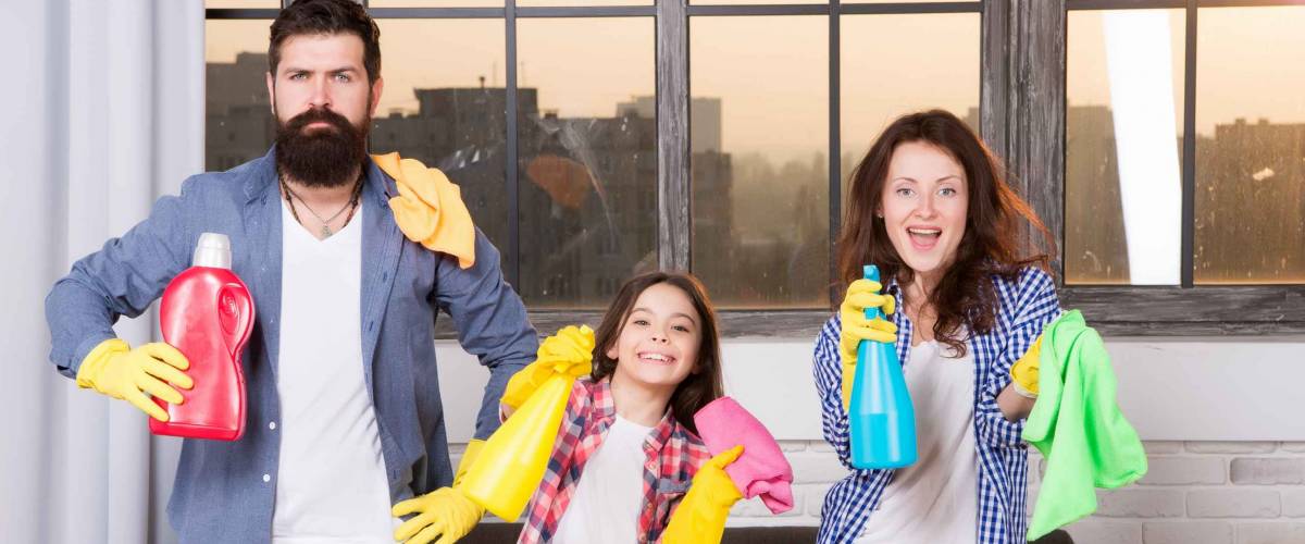 Family clean house. Happy family hold cleaning products. Mother, father and daughter clean house.