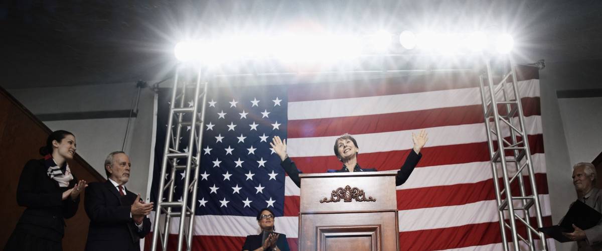 Female politician making speech at podium