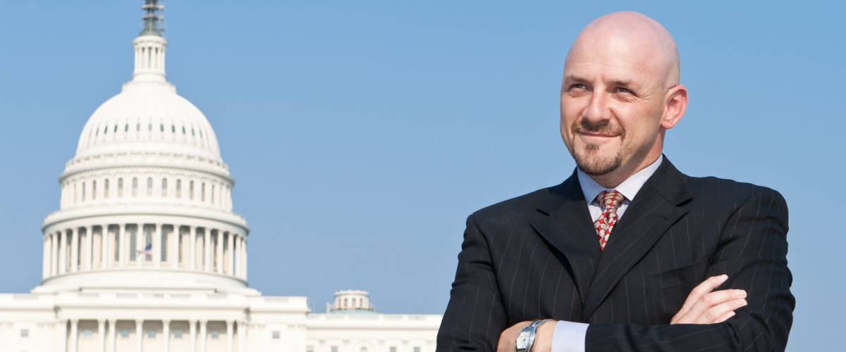 Smiling white man looking at the camera. He's a lobbyist standing outside the U.S. Capitol in Washington DC, United States.