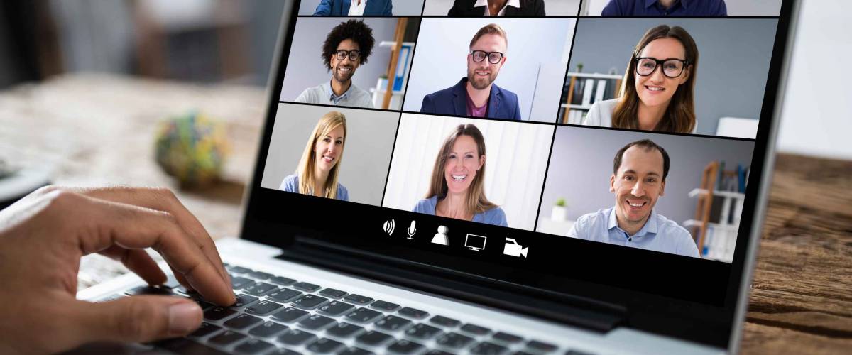 Man Working From Home Having Online Group Videoconference On Laptop