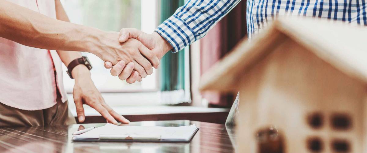 Signing of a real estate contract between buyer and broker.