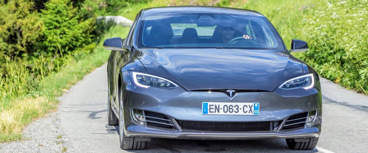 Tesla being driven down a road