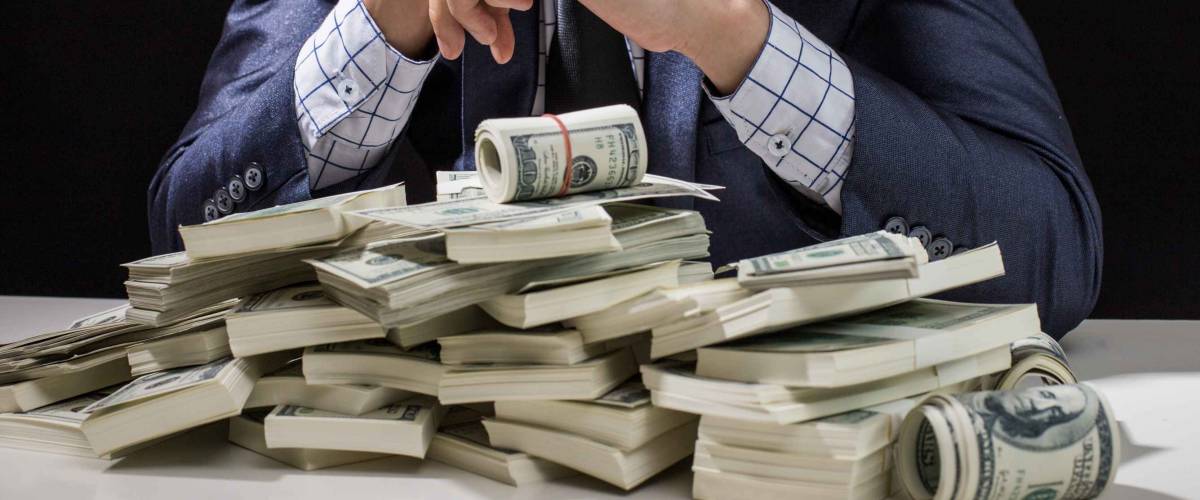 Man holding Money in hand at Black Background, Man receive a lot Money from Trading, Business Success Concept.