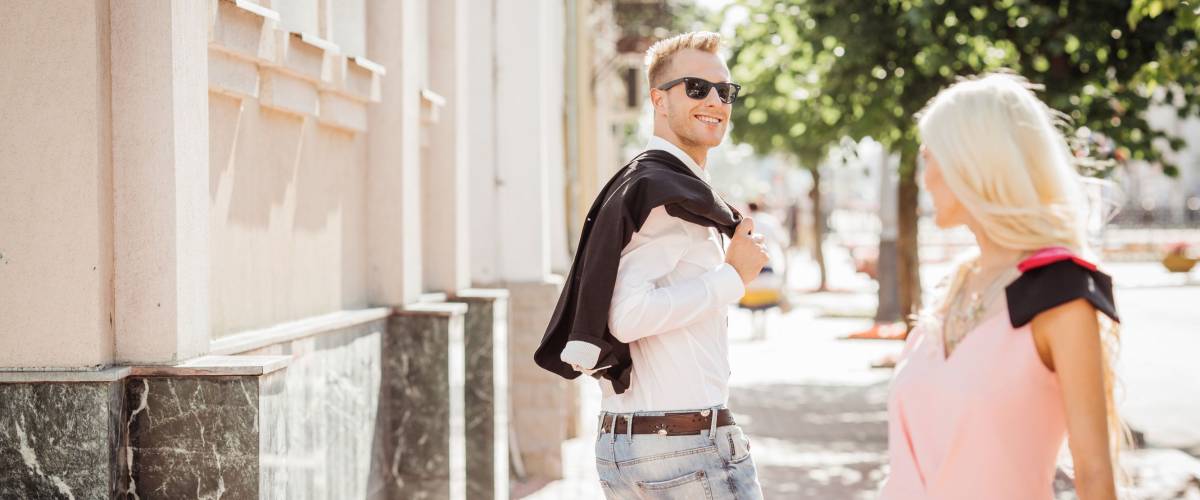 guy looking at a nice girl passing by...while walking at the street
