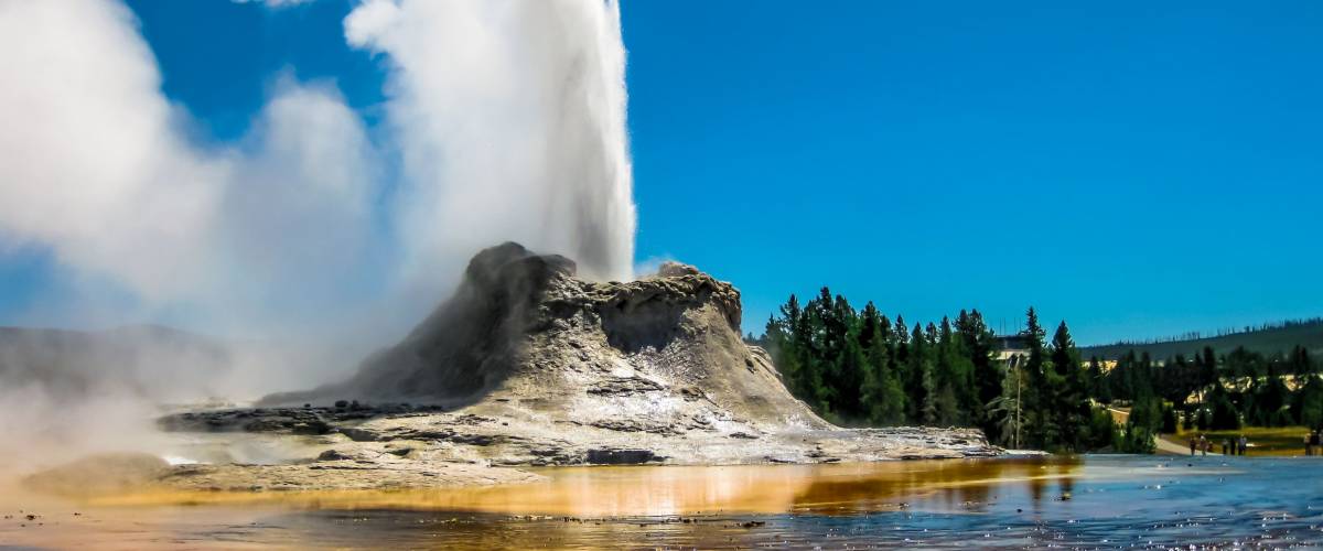 Castle Geyser erupts with hot water and steam with pools of thermophilic bacteria and it's a cone geyser in the Upper Geyser Basin of Yellowstone National Park, Wyoming, United States.