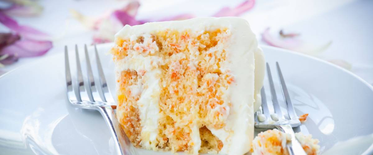 a slice of a wedding cake on dish.