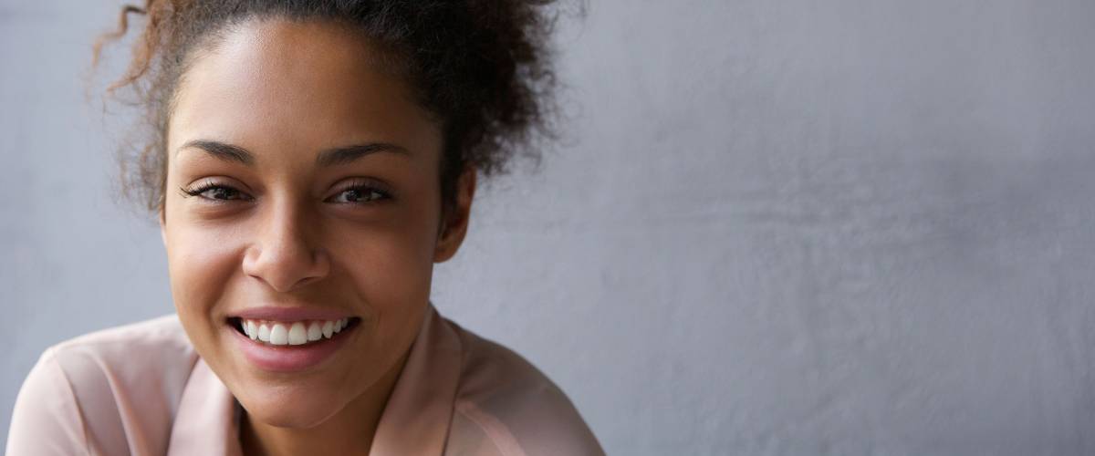 Close up portrait of a happy young black woman smiling