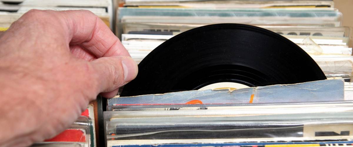 Hand of a man looking at vinyl 7